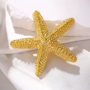 Gold plated textured starfish brooch, elegant marine style costume jewelry accessory for coat.