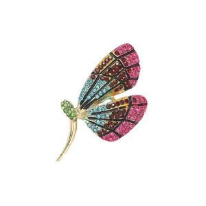 Close-up detail of a colorful rhinestone dragonfly brooch, alloy electroplated pin.