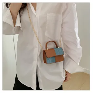 Stylish denim and leather colorblock mini crossbody bag with chain strap for women.
