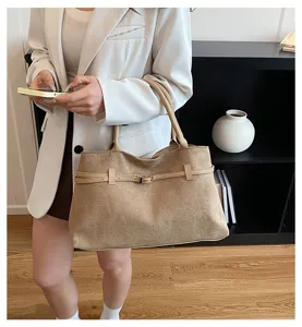 Khaki suede tote bag detail, featuring chic belt accent and retro casual capacity.