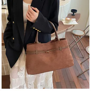 Stylish brown suede tote bag with classic belt detail, perfect for daily fashion wear.