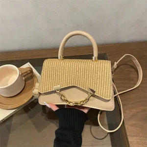 Chic straw woven PU leather handbag with golden chain handle, versatile shoulder bag.
