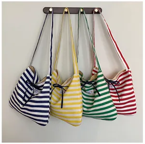 Casual striped canvas shoulder bag with cute bow design, versatile daily underarm handbag.