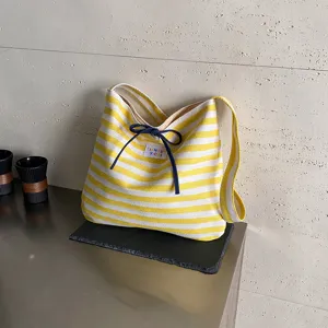 Yellow and white striped canvas shoulder bag with blue bow, casual underarm bag for women.