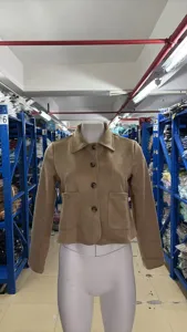 Close-up of women's solid color lapel single-breasted suede short jacket detail view.