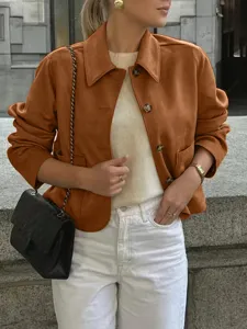Detail view of the retro brown suede jacket with lapel and buttons in urban street scene.
