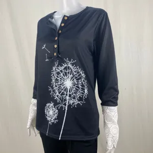 Black ribbed top featuring white dandelion print, Henley buttons, and delicate lace cuffs.