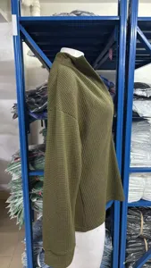 Detail view of women oversized deep v-neck rib knit sweater, solid green casual long sleeve top.