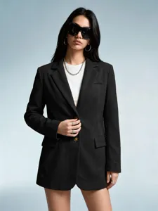 Close-up detail of women's black suede texture blazer jacket, elegant fashion apparel piece.