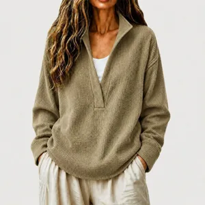 Close-up detail of women's waffle knit deep V-neck casual pullover sweater in khaki color.