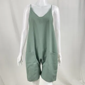 Green romper detail view, spaghetti strap with side pockets, casual summer fashion.