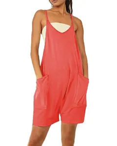 Close-up detail of the red sleeveless romper featuring deep front pockets and thin straps.