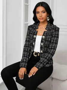 Detailed view of the chic black and white plaid tweed blazer with stylish gold buttons.