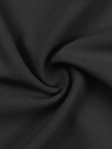 Close-up detail of black fabric showing soft textile texture and twisted swirl pattern.