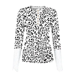 Leopard print long sleeve top detail showing white lace cuffs and wooden buttons.