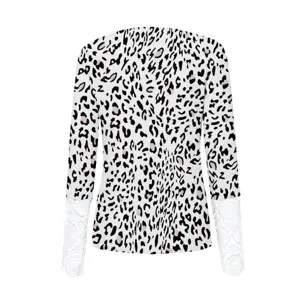 Detailed view of women's long sleeve top featuring leopard print ribbed fabric and white lace cuffs.
