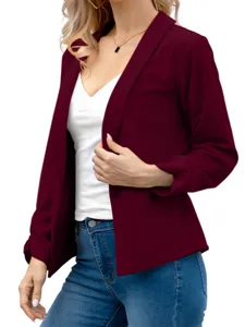Detail shot of a stylish burgundy open-front blazer paired with a white top and blue jeans.