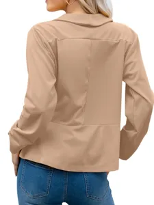 Back view of a chic camel lapel blazer jacket perfectly paired with blue denim jeans.