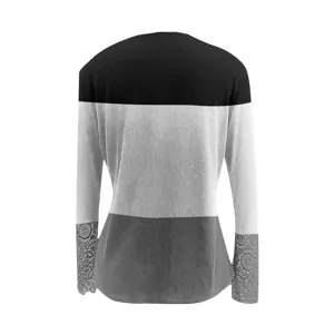 Close-up detail of women's long sleeve ribbed top with delicate lace cuffs and color.