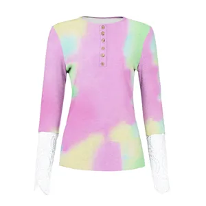 Detailed view of the pastel tie-dye long sleeve top with delicate lace cuffs and buttons.