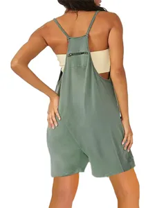 Close-up back detail of the women green romper featuring a zipper pocket and thin straps.