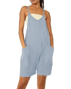 Detail shot of a casual light blue loose romper with large front pockets and thin straps.