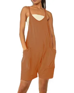 Orange loose sleeveless pocket jumpsuit detail view, casual summer women overall shorts outfit.