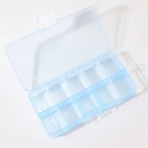 Close-up detail of clear plastic organizer box with multiple compartments and clasp.