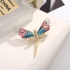 Detail view of a stunning dragonfly brooch featuring rhinestone body and gradient acrylic wings.