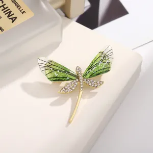Exquisite green acrylic dragonfly brooch detail, sparkling rhinestones, elegant gold metal pin.