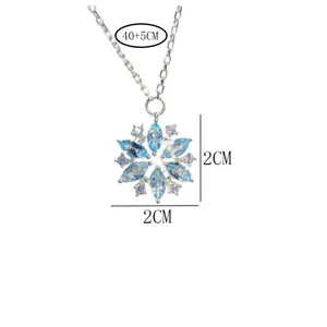 Detailed shot of silver snowflake crystal pendant necklace with blue marquise gems.