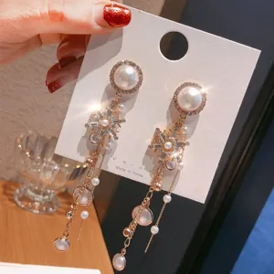Exquisite luxury pearl snowflake rhinestone long tassel earrings detail view, shining charm.