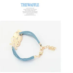 Detail view of the retro blue cord owl charm bracelet, featuring gold hollow design and clasp.