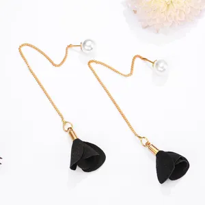Close-up detail of the elegant pearl stud and black fabric rose flower long tassel earrings.