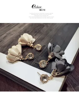 Detailed close-up of elegant fabric rose flower earrings with sparkling crystal rhinestone pendants.