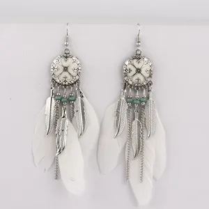 Boho silver plated long feather tassel earrings with ethnic metal medallion and beads.