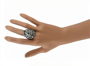 Detail shot of the vintage silver lion head ring, showing intricate metal carving and texture.