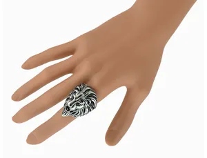 Closeup view of a detailed vintage silver lion head ring worn on hand, gothic retro style.