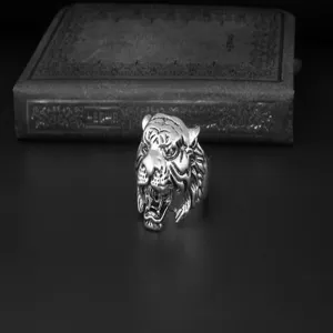 Detailed view of vintage silver tiger head ring, gothic punk style rock men jewelry piece.
