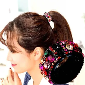 Detailed closeup of a dazzling rhinestone ponytail holder and chic crystal hair clip accessory.