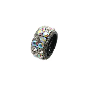 Detailed shot of a round expandable hair clip adorned with sparkling iridescent rhinestones.