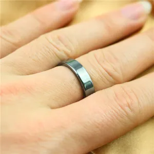 Magnetic hematite ring closeup detail showing multi-faceted cut and dark polished surface.