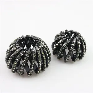 Close-up detail of black rhinestone bird's nest hair bun maker clip, stylish hair accessory.