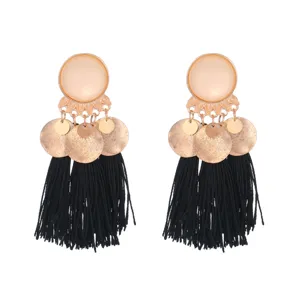 Close-up detail of bohemian alloy metal frosted disc black tassel earrings, stylish design.