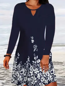 Vestido de mujer manga larga azul marino con cuello en V y estampado floral blanco. Estilo elegante.