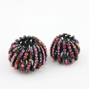 Detailed shot of two stylish rhinestone nest hair claw clips for elegant messy bun hairstyles.