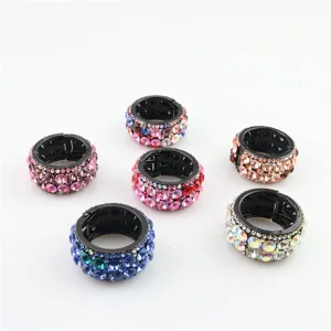 Close-up detail of sparkling rhinestone circular hair clip ponytail holder, multi-color set.