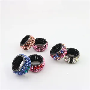 Detailed view of fashionable rhinestone circular hair clips, sparkly crystal ponytail holders for women.