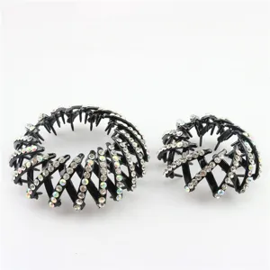 Detailed shot of black rhinestone bird nest hair claw clips, sparkling crystal bun makers.