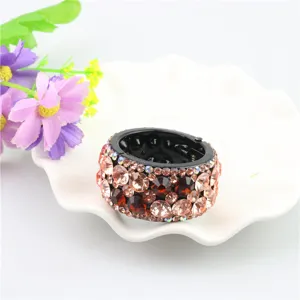 Detailed view of sparkling rhinestone round hair clip ponytail holder, elegant women hair accessory.